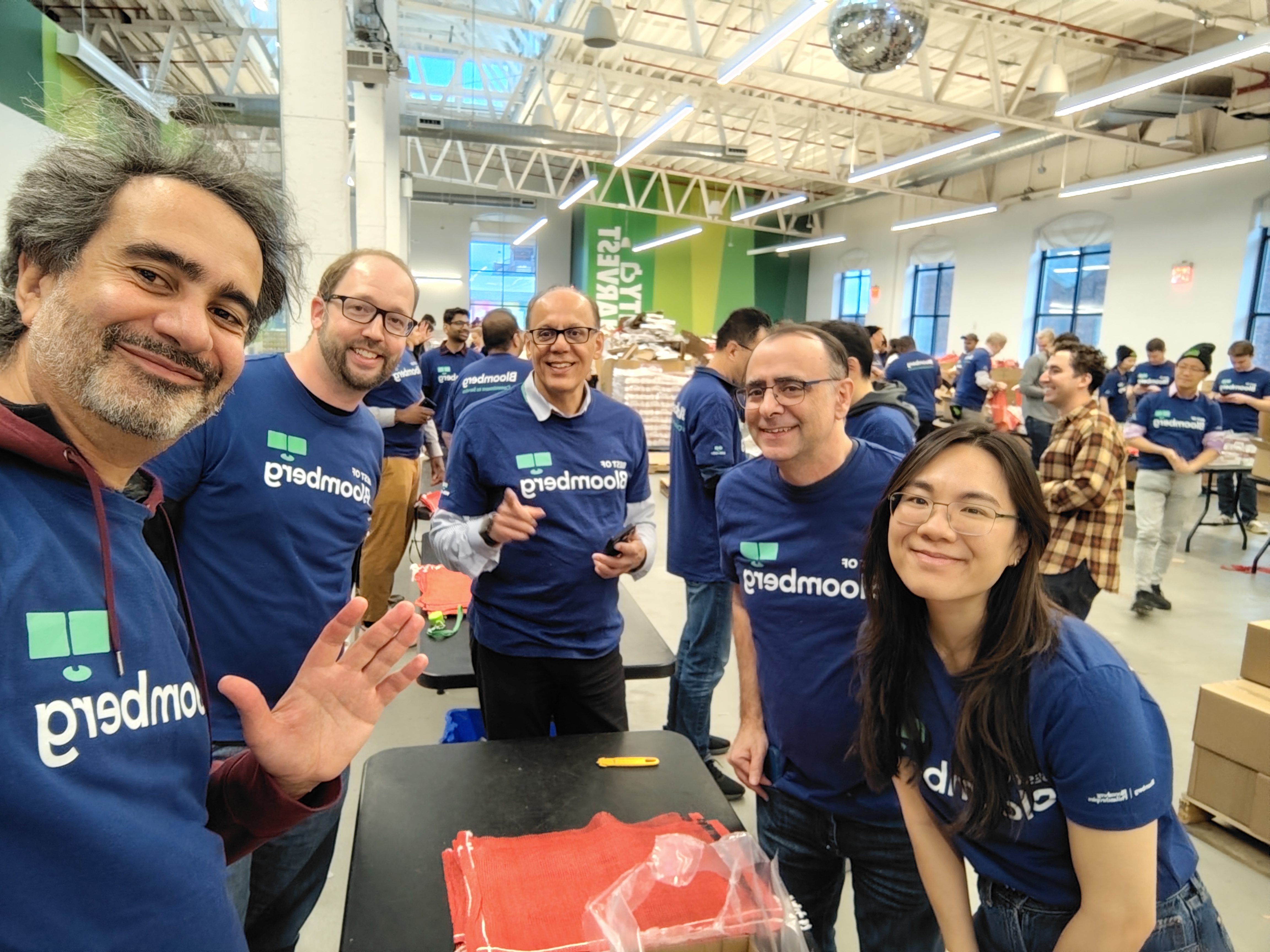 Bloomberg volunteers packing food supplies at a City Harvest warehouse